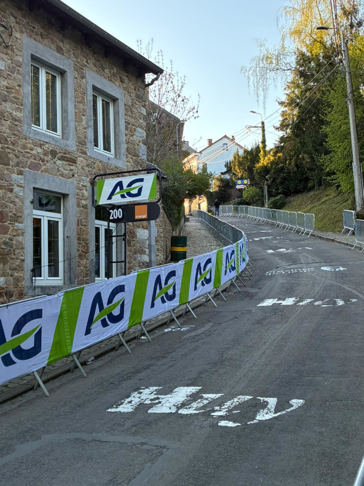 Banderoles personnalisées aux couleurs des sponsors, posées sur barrières d'extérieur — © Doublet